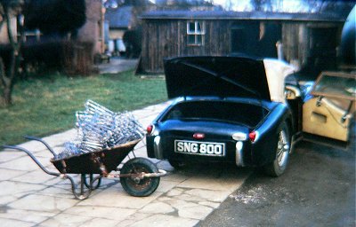 Londing carriers a Triumph TR2 from a wheelbarrow