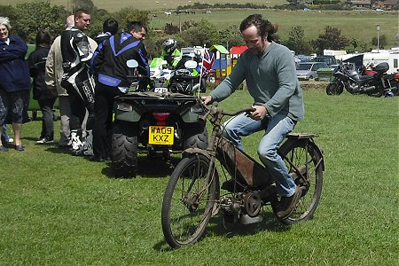 Roly rides his Coventry-Eagle autocycle round the field