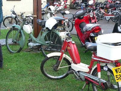 Mopeds scattered around the pub forecourt