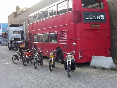 Puch mopeds and a red bus