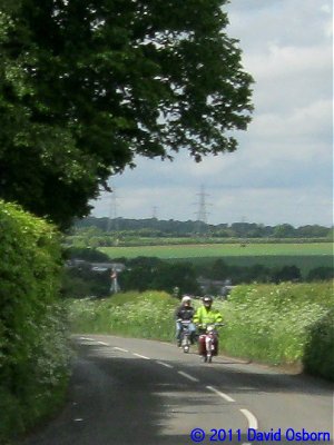 A pair of Puch mopeds approaching